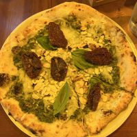 Pizza with pesto, dried tomatoes, pine nuts and almonds.  at Bella Compagnia - Meidlinger Hauptstr. in Vienna
