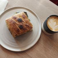 Oat latte and aubergine sandwich at Grain Trip in Bucharest