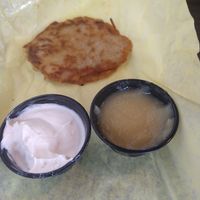 Latke comes with sour cream and applesauce. The best! at Ben & Esther's Vegan Jewish Deli in Portland