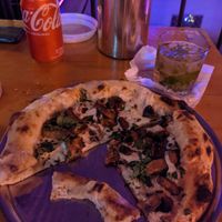 Mushroom pizza baked in brick wood fire oven at Lado V in Buenos Aires