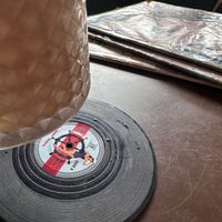 The coaster is a tiny vinyl!!!  at SUSU Vegan Mylk Bar Penang in Penang