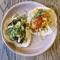 (Left) crispy vegan duck taco: five spiced vegan duck, char sui sauce, toasted sesame mayo, spring onion & cucumber at Wolf at the Door in Manchester