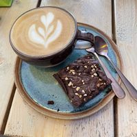 Oatly latte & hazelnut brownie  at The Coffee Hut in Helston