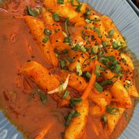 Pastelitos de arroz con salsa dulce picante, verduras y decorada con cebollín   at Lucky Seoul in Guadalajara