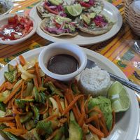 Fajitas in the foreground with tacos in back. at Sac-be Maya  in Xcalakoop