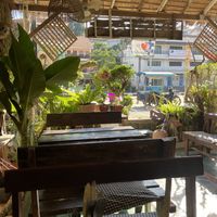 Cosy outdoor seating area with fans at Peak Cafe in Koh Lanta