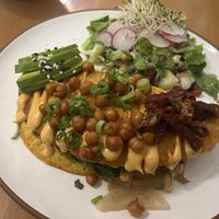 Chickpea omelet with caramelized onions, mushrooms, spinach, crunchy chickpeas and side salad  at Eduardos Hideaway in Noord