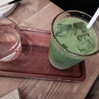 Iced matcha latte with glass of water at Gecko Coffeehouse in East London