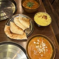 Badami curry (bottom), peshwari naan, pilau rice, chole curry (top)  at Chaat Indian Tapas & Lounge in West Kirby