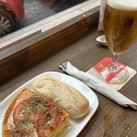 Ración de tortilla napolitana, la sirven con una barrita de pan    at Pasiones Bar  in Gijon