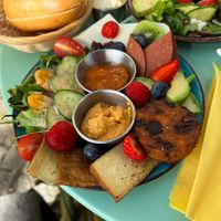 Vegan breakfast with fresh fruit, some salad, bread rolls, Tofu, vegan cheese, jam and a fryer Falafel. 👌  at Cafe MUSTI in Erfurt