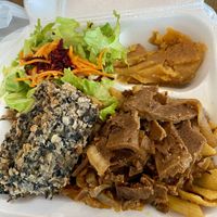 Medium plate with black bean loaf, onion ‘steak’, salad, pasta, and pumpkin.  at Eden's Vegan Eatery in St Croix