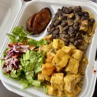 Large plate with salad, plaintains, quinoa, curry tofu, black bean stew  at Eden's Vegan Eatery in St Croix