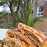 Scrambled tofu in a naan bread, with cheese  at Caked Coffee in Toronto
