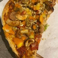 half of the meat pizza at Plant-erian in Krabi