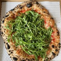 Vegan Boscaiola Pizza: 
San Marzano Tomato Dop, Vegan Mozzarella, Porcini Mushrooms, Rocket Salad & Truffle Oil.  at Paesani in Sheffield