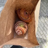 Pistachio cruffin (bottom) and pain au chocolat (top)  at Saint-Jean in Amsterdam