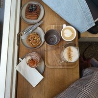 Pumpkin cruffin, cardamom bun, chocolate blueberry danish, chai latte with pea milk and a cappuccino. at Saint-Jean in Amsterdam