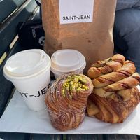oatmilk latte and cappuccino, pistachio cruffin, pain au chocolat, cinnamon bun  at Saint-Jean in Amsterdam