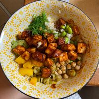 General Tao Tofu with sushi rice, seaweed, edamame, mango, chickpeas, and olives  at Bol de Vie in Montreal