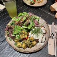 Tofu chimichurri, patatas alioli, salad  at Honest Greens - Tuset in Barcelona