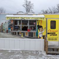 Cute Little Trailer and Space with Outside Tables and Fake Palm Trees at Carmen's Sabor Latino in Napanoch
