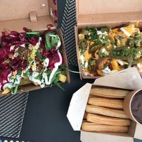 Pink Persia Poutine (left), chili cheese fries (right), and churros with chocolate sauce at Frittenwerk - Hbf Leipzig in Leipzig