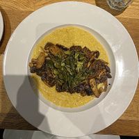 Blackened Mushrooms and Grits (blackened mushroom medley served over vegan cheddar grits;
garnished with pickled collard greens) at Maple Tree Inn in Homewood