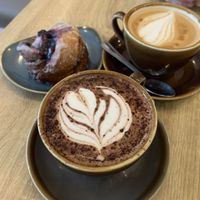 Oat latte, oat hot chocolate, and a berry Cinnamon Bun   at Fika in Bournemouth