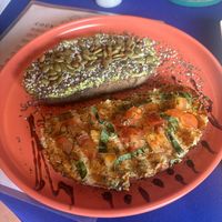 Sourdough toast with avocado and seeds and then hummus tomatoes, basil and balsamic   at Dushi Delicious  in Oranjestad
