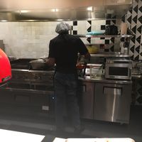Server scooping the food to prepare the bowl (it takes only two minutes between when you order and when you are served) at Teranga - Midtown in New York City