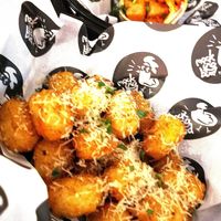 Topped Tots with Black Garlic Butter and parmesan at Mockingbird - Food Stand in Grimsby