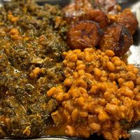 Asun Mushrooms with spinach, stewed beans, fried plantains at Funmi's Cafe in Louisville
