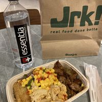 Vegan Jerk Bowl with Jamaican fried rice, scotch bonnet cauliflower, peppers & onions, yuca fries, and mango salad. at Jrk! in Aventura