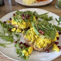 Avocado toast with “vegan egg” and pomegranate seeds   at Mamafood in Prague