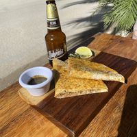 Vegan carnitas quesadilla with super spicy verde habanero salsa and a cold Bohemia oscura  at La Taqueria in Tulum