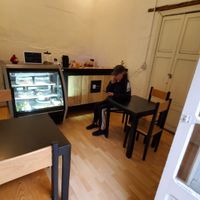 Two tables inside and one outside. at La Mandioka in Toluca