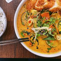 Red curry with breaded tofu, vegetables, and rice on the side. at Mon in Berlin