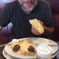 Something called "the cheese boat" with Daiya cheese,  vegan Italian meatballs and Alfredo noodles. That's Go Veggie! parmesan on the table.  at Razzi's Pizzeria - Greenwood Ave in Seattle