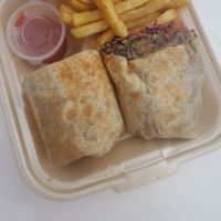 Vegan Wrap: coconut rice, black beans, cabbage, onions, tomato, and peppers with smoky chipotle vegan dressing at The Coconut Husk Restaurant & Beach Bar in Hopkins