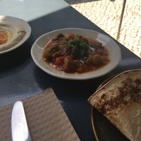 Part of vegetarian mezze (made vegan) : hummus, okra stew, syrian flat bread at Mezze in Lisbon