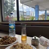 Fried rice and fried noodles. Looking out over the electric car charging forecourt - seating outside as well.  at Asian Box in Rose Hill