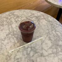 Acai smoothie; table inside shop. at Oakberry - Greenwich Village in New York City