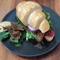 Croissant with hummus, seitan, fermented veggies, carrots salmon at Formidable Pelikan in St Gallen