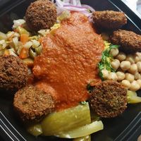 basmati, chickpeas, red onion, Arabic pickles, hot peppers, parsley, falafel and fire sauce at Pita or Bowl in Springfield