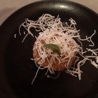 A hello from the kitchen. Fried potato batter with rice noodle crispies. at ARROI Restaurant in Bled