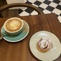 Cappuccino and cinnamon roll  at Hygge in Lisbon