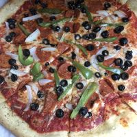 Vegan pizza with peppers, onions, olives, and vegan pepperoni  at Anika's Pizza in Moultonborough
