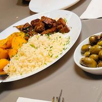 Daily typical plate of rice, potatoes and seitan, olives, and a kind of "porc" sandwich, spicy and juicy and yummy. at Lupin Snack Bar in Porto