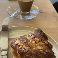 Almond croissant & soy cortado  at Fika+ in Chester